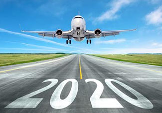 Airplane landing on runway with 2020 written on it